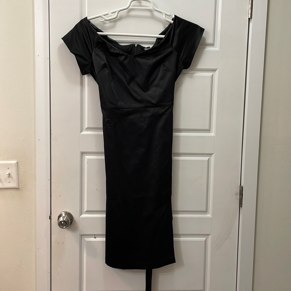 New tags still on black below the knee dress.